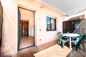 a dining room with a table and chairs at Appartamenti Cavour cod C in Villasimius
