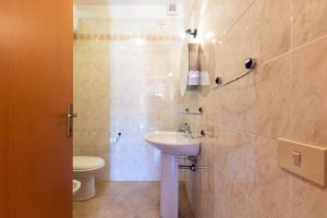 a bathroom with a sink and a toilet at Appartamenti Cavour cod C in Villasimius +17 photos