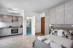 a large room with a bed and a kitchen at Edda's apartment in Altare