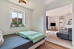 a bedroom with a bed and a living room at Ferienwohnung Schwarzwaldmädel in Seelbach