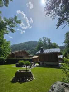a house with a yard with a building with a roof at Chalet Pierre d Anatase in Saint-Gervais-les-Bains
