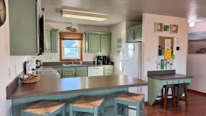 a kitchen with green cabinets and a counter top at Carolina Breeze in Rodanthe