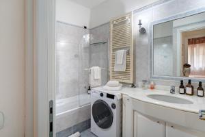 a bathroom with a washing machine and a sink at Salice Felice in Ventimiglia +20 photos