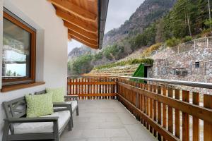 a balcony with benches and a view of a mountain at Löchlerhof in Ritten