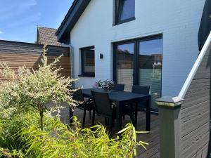 a patio with a black table and chairs at Küsten-Bude in Elmenhorst