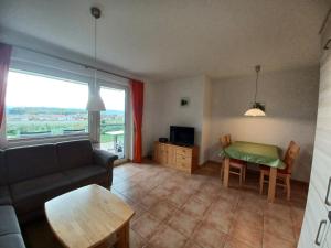 a living room with a couch and a table at Landhaus Erben in Wasserburg