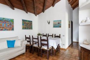 a living room with a table and a couch at Villa Romana in Costa Rei