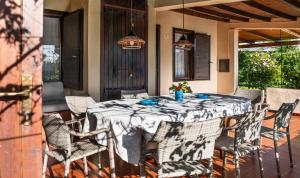 a table and chairs on a patio at Villa Romana in Costa Rei