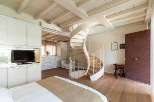 a bedroom with a spiral staircase in a room at Appartamento Bacco in Lido di Camaiore +15 photos