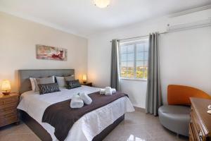 a bedroom with a large bed and a window at Villa Martinique in Albufeira +34 photos
