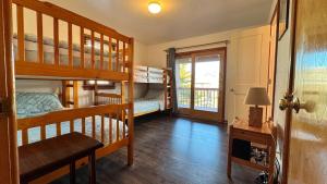a room with bunk beds and a hallway with a window at Carolina Breeze in Rodanthe +64 photos