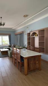 a living room with a table and a couch at Yak villa in Kushālnagar