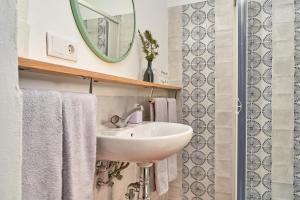 a bathroom with a white sink and a mirror at Cortijo de Arriba in Frigiliana