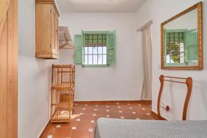a room with a mirror and a wooden ladder at Cortijo de Arriba in Frigiliana