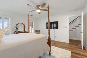 a bedroom with a bed and a ceiling fan at Red Bluff Cottage in Montgomery +16 photos