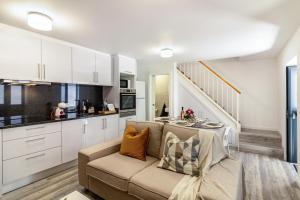 a living room with a couch and a kitchen at Casa do Porto in Paul do Mar +14 photos