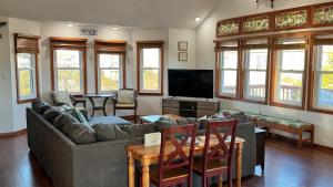 a living room with a couch and a television at Carolina Breeze in Rodanthe