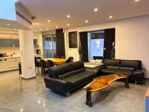 a living room with a couch and a table at Luxury Duplex With Private Pool in Eilat