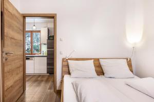 a bedroom with two beds and a kitchen at Goodlife Top 1 in Saalbach-Hinterglemm