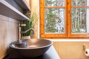 a sink in a bathroom with a window at Goodlife Top 1 in Saalbach-Hinterglemm +17 photos