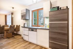 a kitchen with a sink and a table in a room at Goodlife Top 1 in Saalbach-Hinterglemm