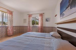 a bedroom with a large bed and two windows at Casa Marron in Costa Calma +99 photos