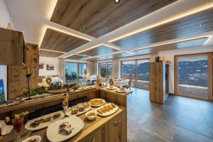 a kitchen with a table with food on it at Eichernhof Apartment Marillenblüte in Verano