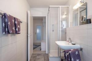 a white bathroom with a sink and a shower at Ferienwohnung Dachtler in Hinterzarten +30 photos