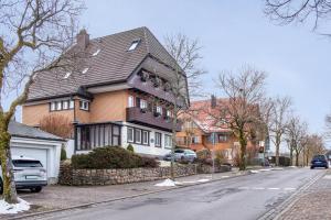 a large house on the side of a street at Ferienwohnung Dachtler in Hinterzarten