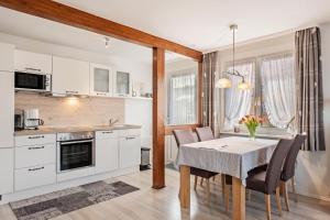 a kitchen and dining room with a table and chairs at Ferienwohnung Dachtler in Hinterzarten