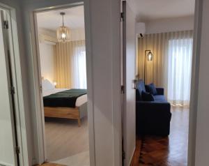 a room with a bedroom and a bed and a couch at Casa dos Avós in Cascais +54 photos