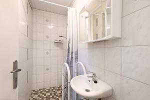 a white bathroom with a sink and a mirror at Ferienbungalow 2 in Boitzenburg in Boitzenburg