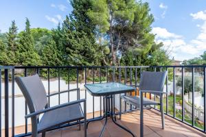a patio with two chairs and a table on a balcony at Dorada Apartment Sol in Calafell