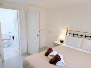 a bedroom with a bed with two towels on it at Salton Lodge Barns in Great Edston