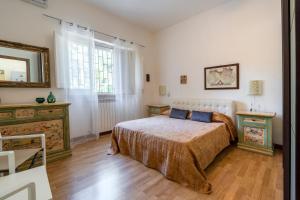 a bedroom with a bed and a mirror on the wall at Villa Massa in Polignano a Mare +31 photos
