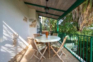 a patio with a table and chairs on a balcony at Villa Massa in Polignano a Mare