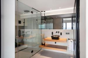 a bathroom with a sink and a glass shower at Gran Suite Horizonte in Puerto del Carmen +14 photos