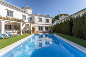 a swimming pool in the backyard of a house at Villa Eden Nerja in Nerja