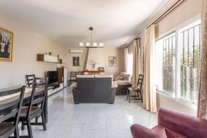a living room with a couch and a table at Villa Eden Nerja in Nerja
