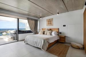 a bedroom with a large bed and a large window at Gran Suite Horizonte in Puerto del Carmen