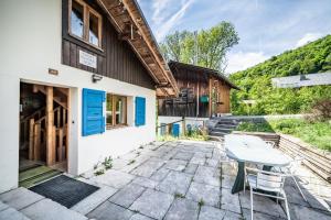 a patio with a table and a building at Chalet Elisthur in Saint-Jean-d'Aulps