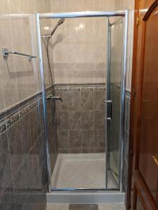 a shower with a glass door in a bathroom at Casa Luzia in Miami Platja +14 photos