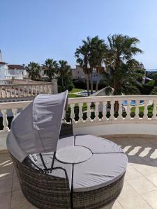 a chair sitting on a patio next to a fence at Casa Luzia in Miami Platja