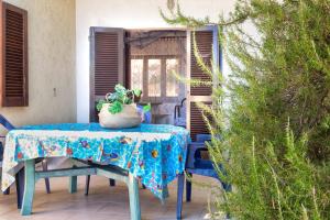 a table with a potted plant on it on a patio at Fantastico quadrilocale vista mare in Trinità d'Agultu e Vignola
