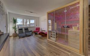 a living room with a large sliding glass door at Luxus Chalet Landhaus Rachelblick in Eppenschlag