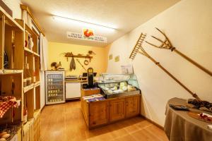 a kitchen with a refrigerator and a counter with food at Rieglhof Apartment Geiernest in Curon Venosta +21 photos