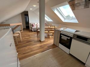 a kitchen and dining room with a skylight at Dreams im Obergeschoss in Koetz 