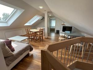 a living room with a couch and a dining room at Dreams im Obergeschoss in Koetz 