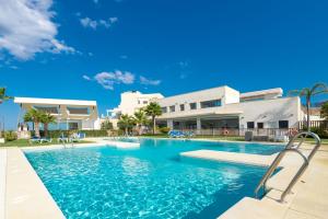 a swimming pool in front of a house at Penthouse Banderas with own pool in La Cala de Mijas