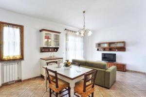 a living room with a green couch and a table at Casa Consuelo App. 1 (trilocale) in Capoliveri